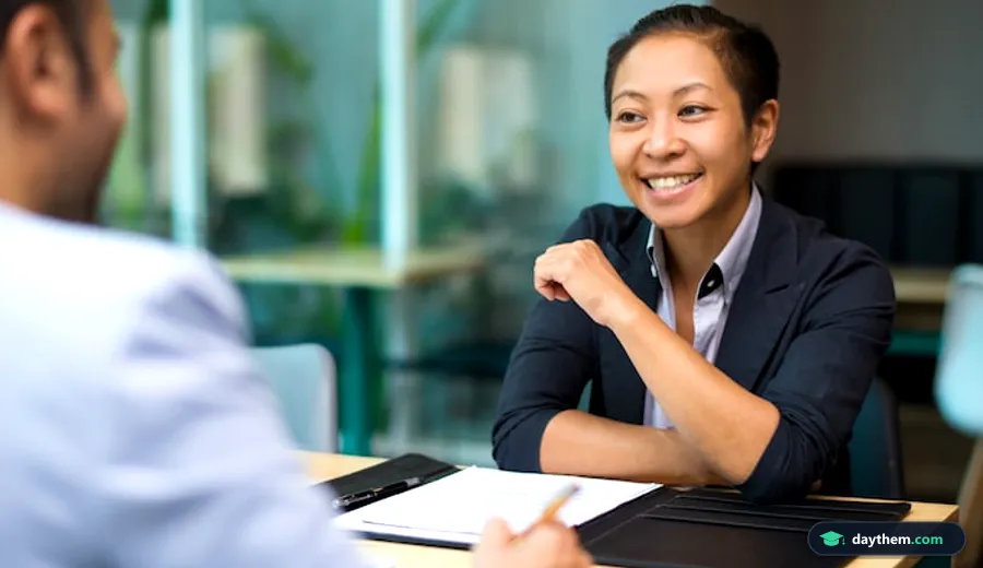 Nữ nhân viên mỉm cười hứng khởi khi tán thành ý kiến của đồng nghiệp trong buổi trao đổi kỹ năng giao tiếp và phỏng vấn